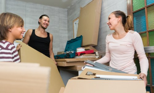 Movers using safe lifting practices during a residential relocation