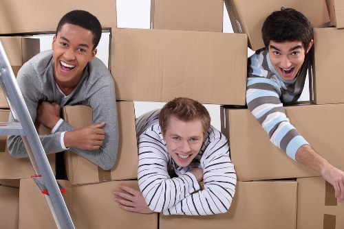 Helper carrying boxes during a Knightsbridge flat move