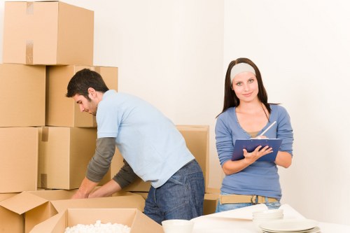 Professional office movers handling desks and IT equipment in central London